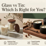 Glass vs tin candle vessels comparison — premium clear glass jar candles with wooden lids beside matte black tin candle containers, styled on marble and wood surfaces by Welburn Candles